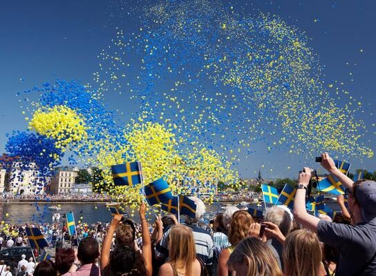 swedish festival with balloons in the air and people celebrating