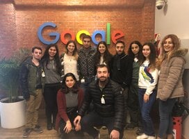 group of participants in front of google sign 