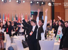 Students wave at aModel G20 Youth Leadership Summit
