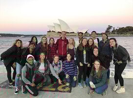 Students striking a pose in front of the famous Sydney Opera House.