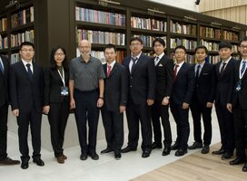 Law interns taking a group photo with their boss and collegues
