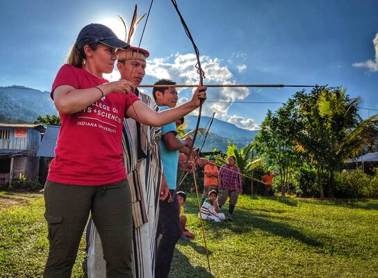 Professor Julie Madewell from Indiana University shoots and bow and arrow