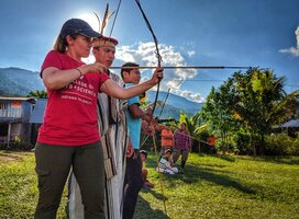Professor Julie Madewell from Indiana University shoots and bow and arrow
