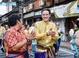 Teacher and student laugh in a street festival