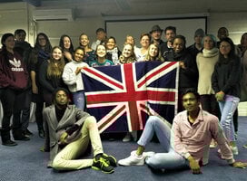 Graduates pose in front the British flag in Cape Town
