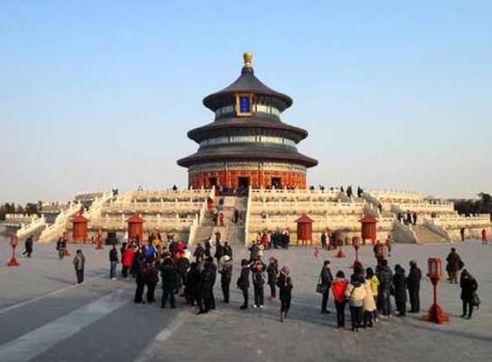crowd of people standing in front of Chinese temple with 