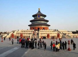crowd of people standing in front of Chinese temple with 