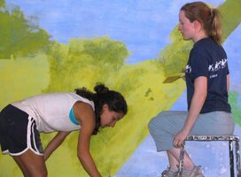 Volunteers decorating class-room walls.