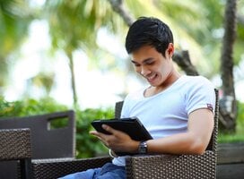 Young man completing his TEFL training on a tablet