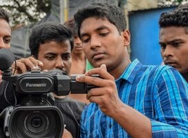Young men using video camera