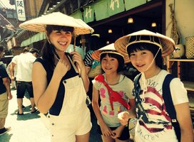 American girl with Japanese host sisters wearing traditional hats
