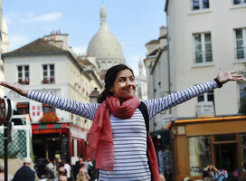 Girl with arms outstretched, taking in the beauty of France