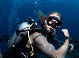 Scuba diver flexing his muscles underwater