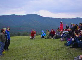 Mongolia Field School 2019 participants gather by the Eg River Science Camp as the course leader briefs them