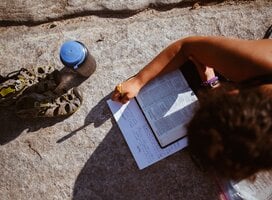 girl studying bible by Lake Superior