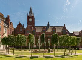University of Liverpool campus surrounded by green trees & grass and our historic red brick buildings