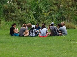 Participants in a circle outdoors 