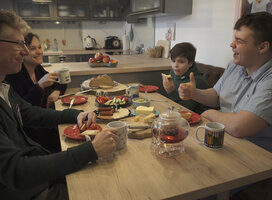 A student enjoing dinner with his host family