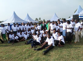 A  team of 4s volunteers posing posing for photo with South Korea Ambassador to Uganda 