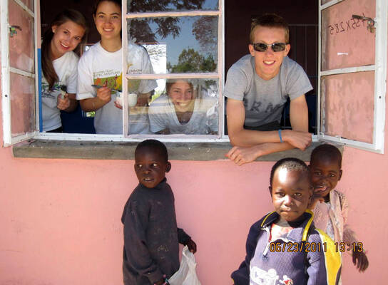 Volunteers look out from classroom