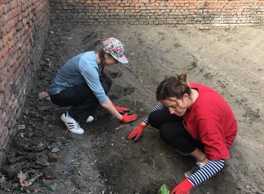 Volunteers in Nepal planting vegetable garden