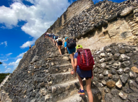 Students climb up the steps at the Mayan ruins at Xunantunich.