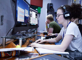 Girl with headphones at computer