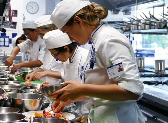 Students in the kitchen during Cuisine Diploma program at Le Cordon Bleu