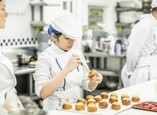 Students in the kitchen during Boulangerie program at Le Cordon Bleu