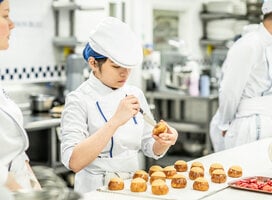 Students in the kitchen during Boulangerie program at Le Cordon Bleu