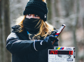 the 2nd AC holds up a slate at the start of a take