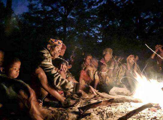 San Bushmen sitting around the fire at a Healing dance event