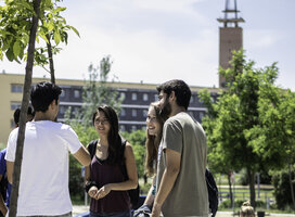 Students on campus with University tower in the background