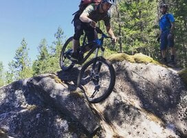 Student learning bike skills on slick rock