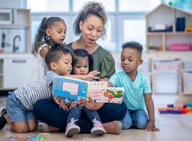 Women reading to group of children