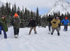 Youth running on snowshoes towards camera