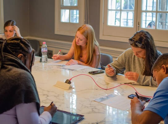 Sage Corps interns working together on their group presentation