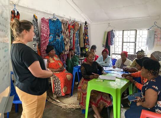 A Volunteer with women during session.