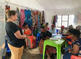 A Volunteer with women during session.