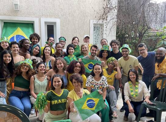 Students, faculty, and staff posing for a photo during a World Cup 2022 watch party