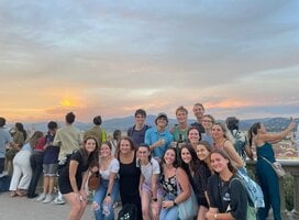 A group of CET Florence students posing in front of a sunset