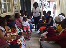 A nurse doing reproductive health education to young ladies within a community setup