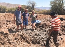 3 students preparing the mud to make adobe bricks