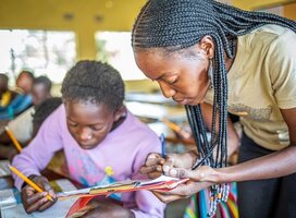 local teacher in Zambia assisting a student