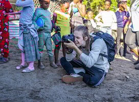 Impact Photography volunteer with community children