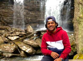 Spirit intern in front of a waterfall