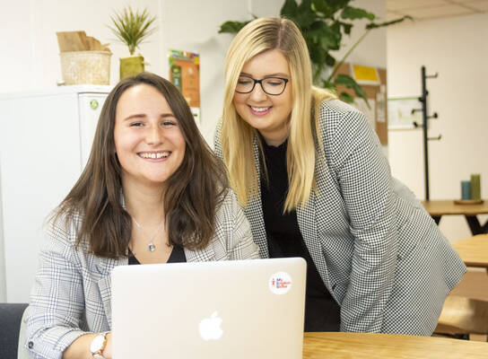 Two interns working at the office