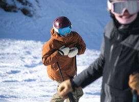Women smiling at camera while skiing