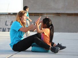 HOOP volunteer playing with student