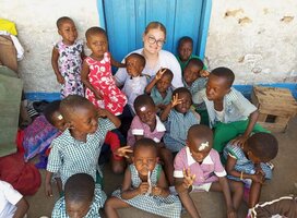 Childcare volunteer with children at James Town Gbekebii school in Accra